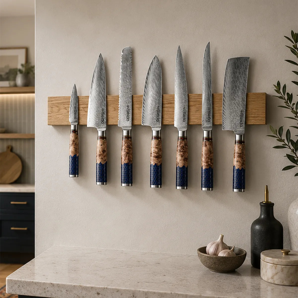Handcrafted white oak magnetic knife bar with seven kitchen knives.