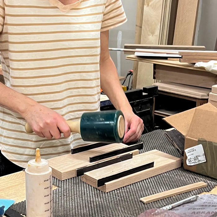 Asha Louise assembling solid wood components for a handmade knife block