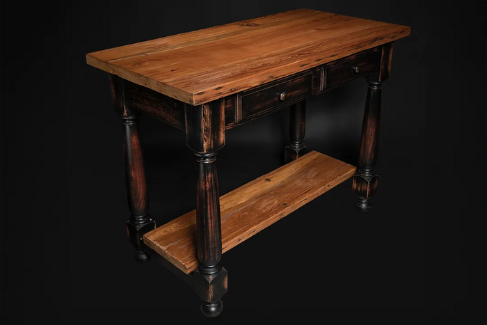 Autumn Leaves rustic kitchen island shown at an angle—reclaimed heart pine top, black distressed pine base with two drawers and an open shelf.