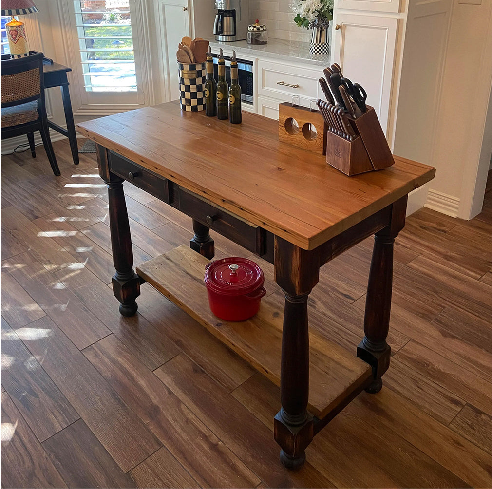 Autumn Leaves custom kitchen island in reclaimed heart pine with turned legs, drawer storage, and lower shelf.
