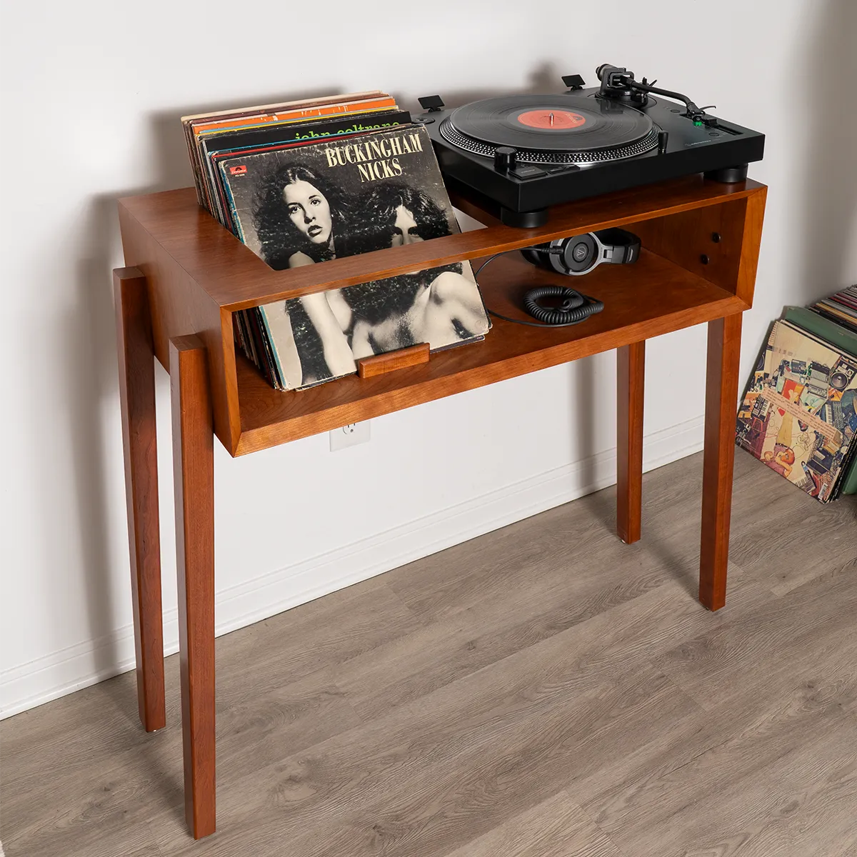Close-up of She’s a Lady cherry record player stand, mid-century modern vinyl storage cabinet with upright record display and turntable platform