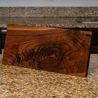 Chatoyance visible in figured walnut grain on a handcrafted magnetic knife block
