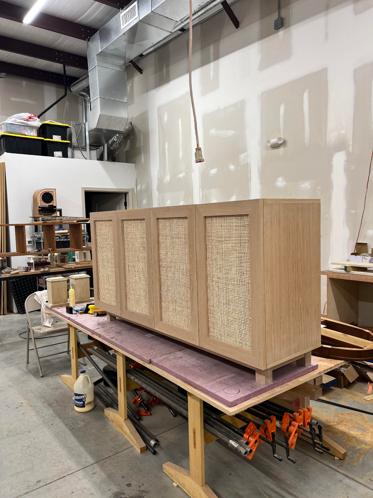 Side angle of white oak rattan media console showing clean lines and construction.