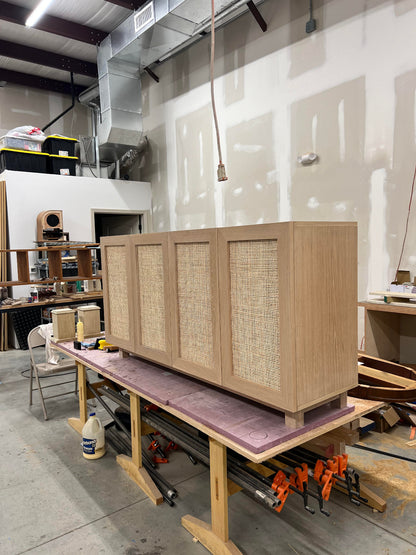 Side angle of white oak rattan media console showing clean lines and construction.