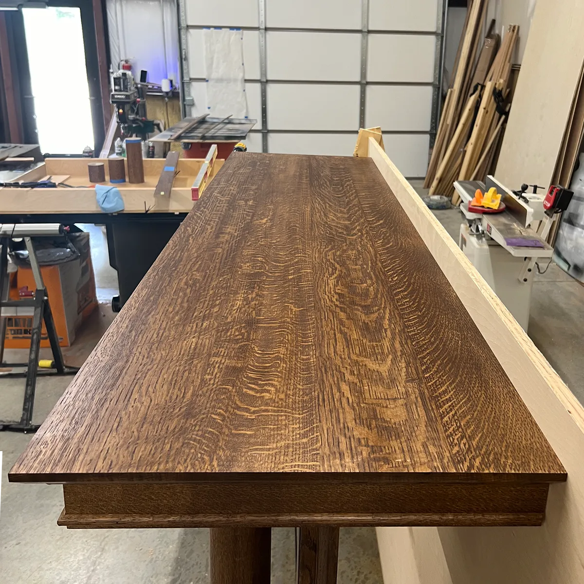 Custom fireplace surround in bleached quarter-sawn white oak, showing neutral finish and beautiful wood grain on the mantel shelf