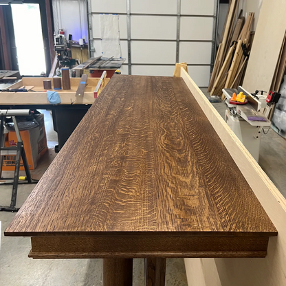 Custom fireplace surround in bleached quarter-sawn white oak, showing neutral finish and beautiful wood grain on the mantel shelf