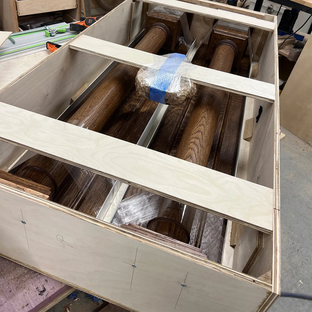 Custom wooden shipping crate designed for safe delivery of a handcrafted fireplace surround, showing protective packing and sturdy construction