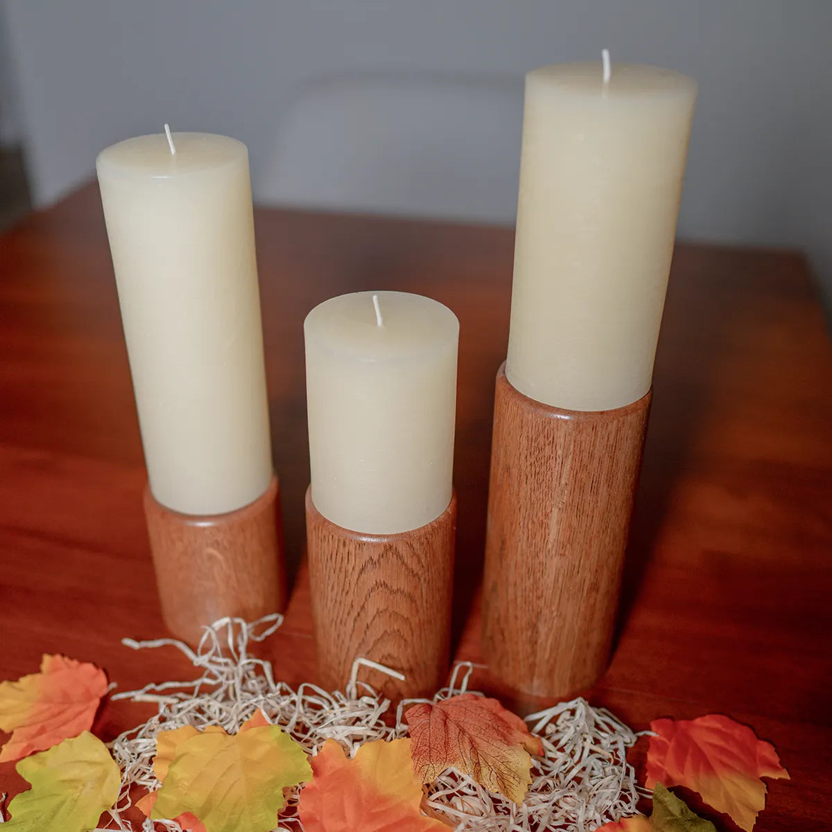 Fire & Rain pillar candle holders displayed on a table as home decor, showing their unique shapes and warm finish.
