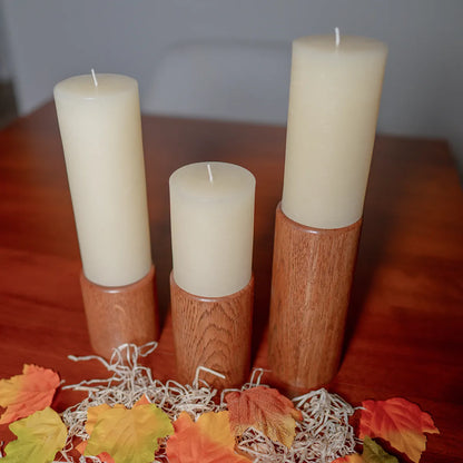 Fire & Rain pillar candle holders displayed on a table as home decor, showing their unique shapes and warm finish.