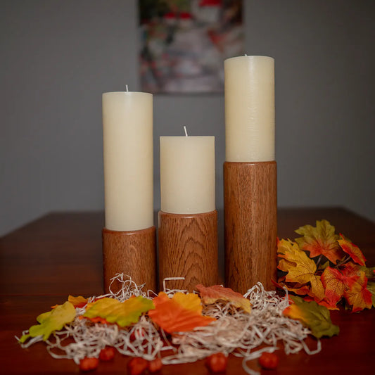 Set of three handmade pillar candle holders in cherry wood, Fire & Rain series, shown together on a white background