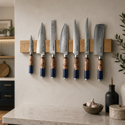 Handcrafted white oak magnetic knife bar with seven kitchen knives.