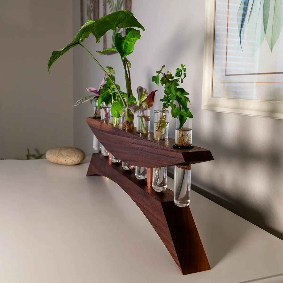 Angled view of handmade plant propagation vase in walnut with polished copper standoffs and seven glass test tubes