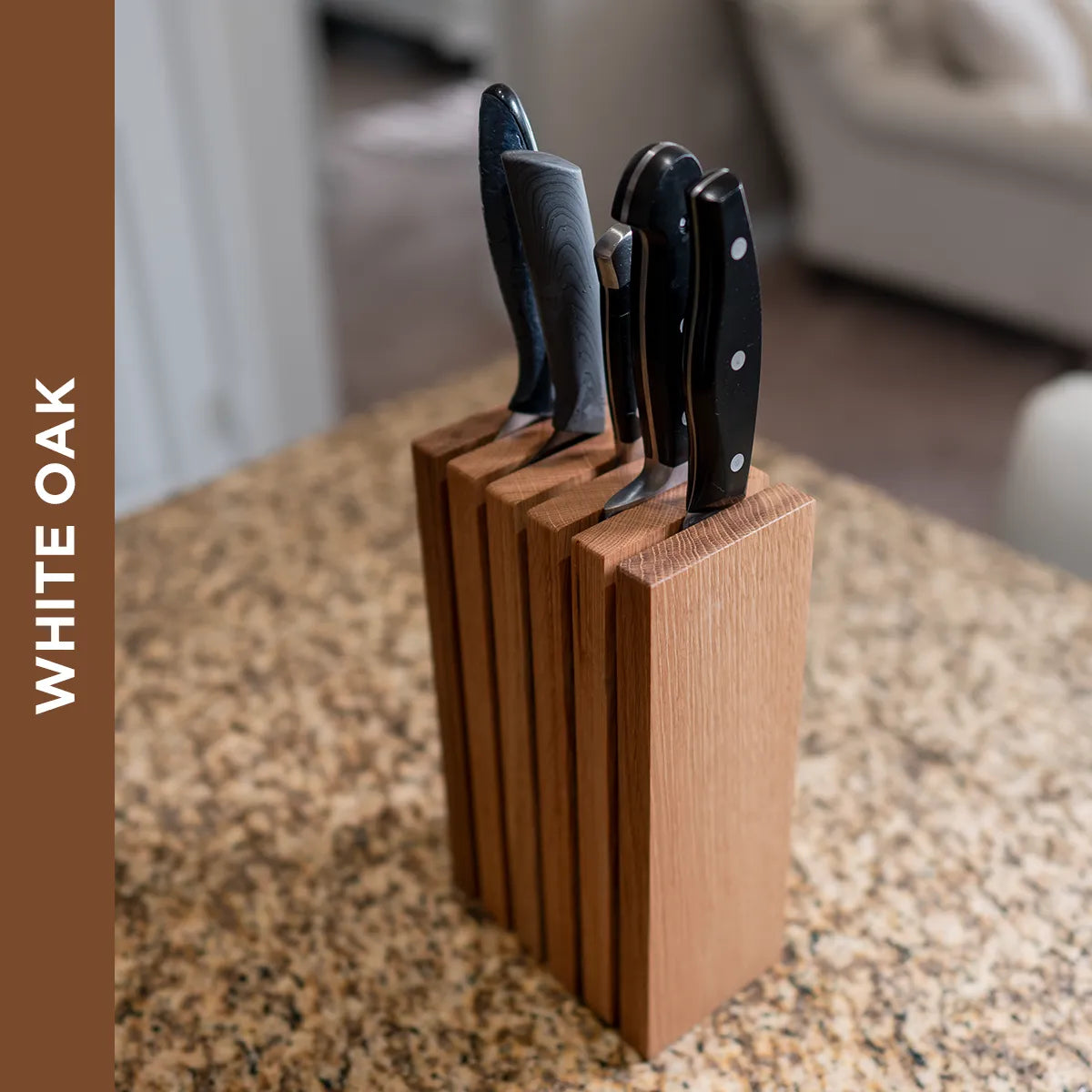 Angled view of The Chain knife block in white oak holding kitchen knives