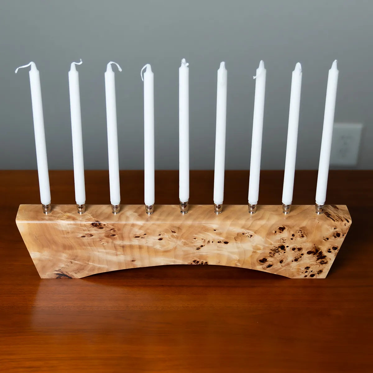 Top view of the Hey Jude menorah in solid Mappa burl with polished nickel candle cups