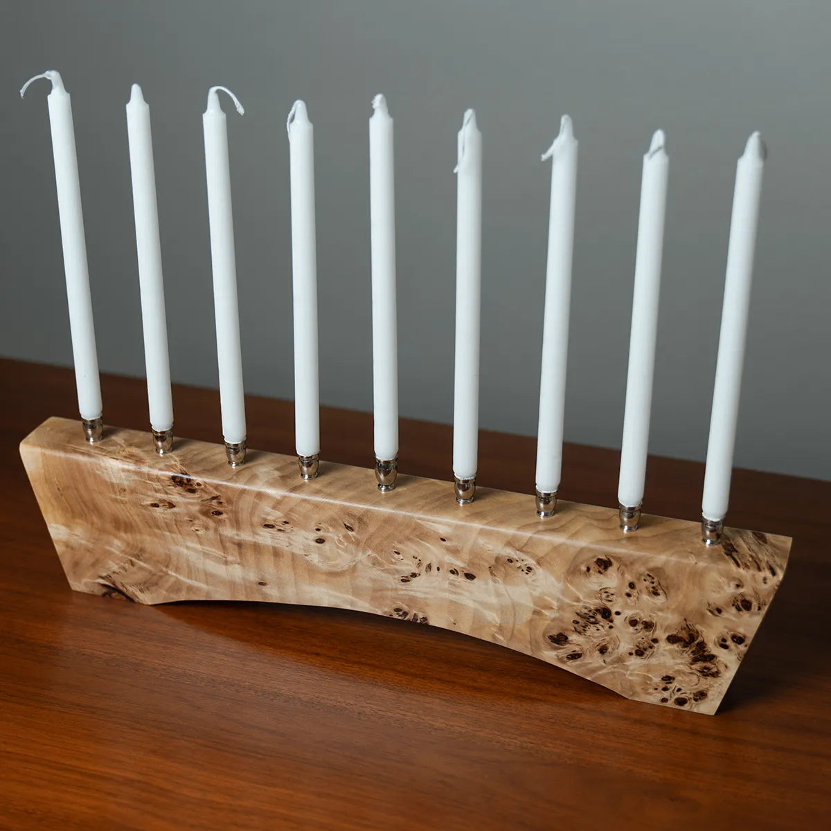 Side view of solid Mappa burl menorah signed and numbered