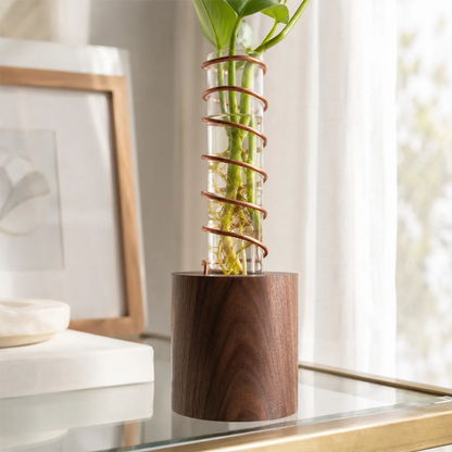 Handmade Lean on Me propagation vase with a solid walnut base, polished copper support, and oversized glass tube for plant cuttings.