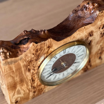 detail view of a one-of-a-kind mappa burl mantel clock with classic brass dial and sculptural wood contours