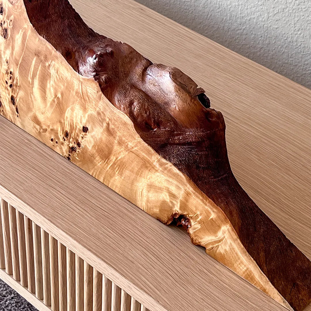Close-up of the natural live edge on a Signature Series mappa burl mantel clock, showing the unique, organic wood contour.