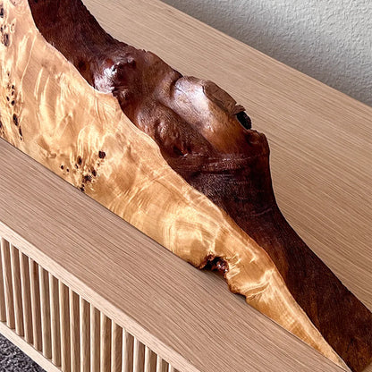 Close-up of the natural live edge on a Signature Series mappa burl mantel clock, showing the unique, organic wood contour.