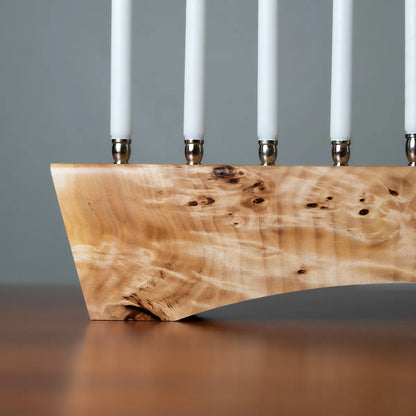Close-up of handmade menorah in Myrtle burl with polished nickel candle cups