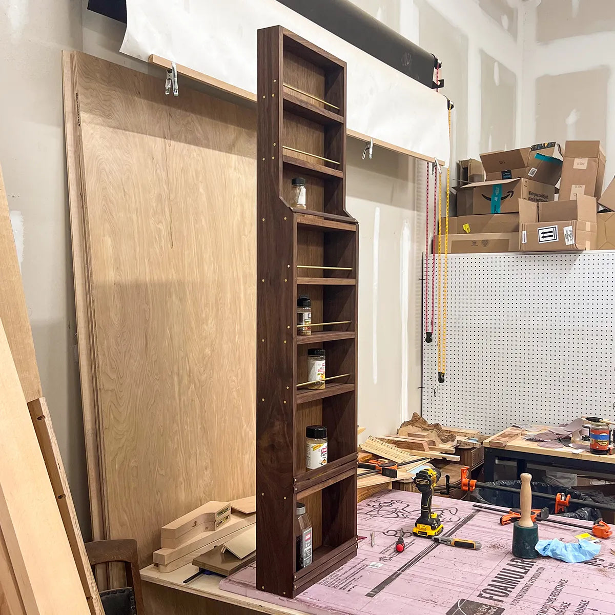Side view of A Taste of Honey walnut spice rack showing the stepped transition from shallow upper shelves to deeper lower shelves.