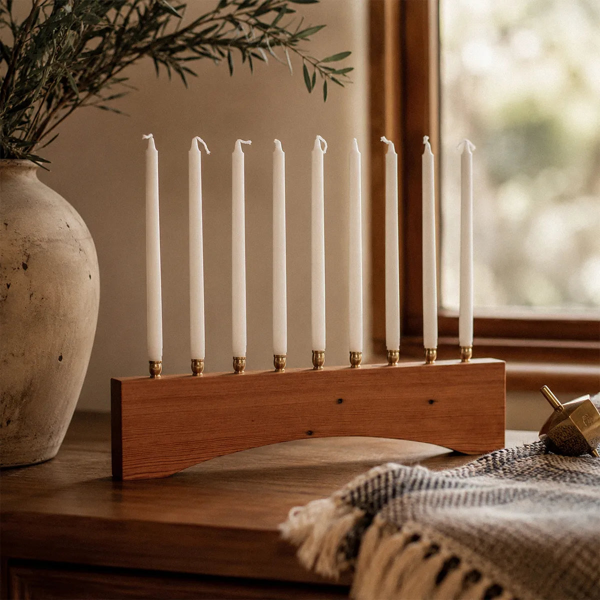 Modern farmhouse Hanukkah menorah handmade from reclaimed heart pine with an arched base and nine brass candle holders