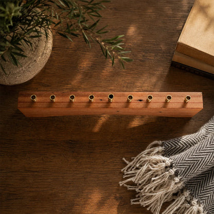 Overhead view of a modern farmhouse Hanukkah menorah in reclaimed heart pine with nine brass candle cups set into the wood