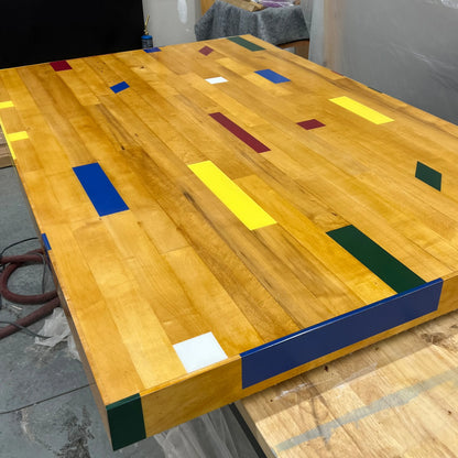 Salvaged gym floor maple boards with painted court lines, layering an epoxy finish