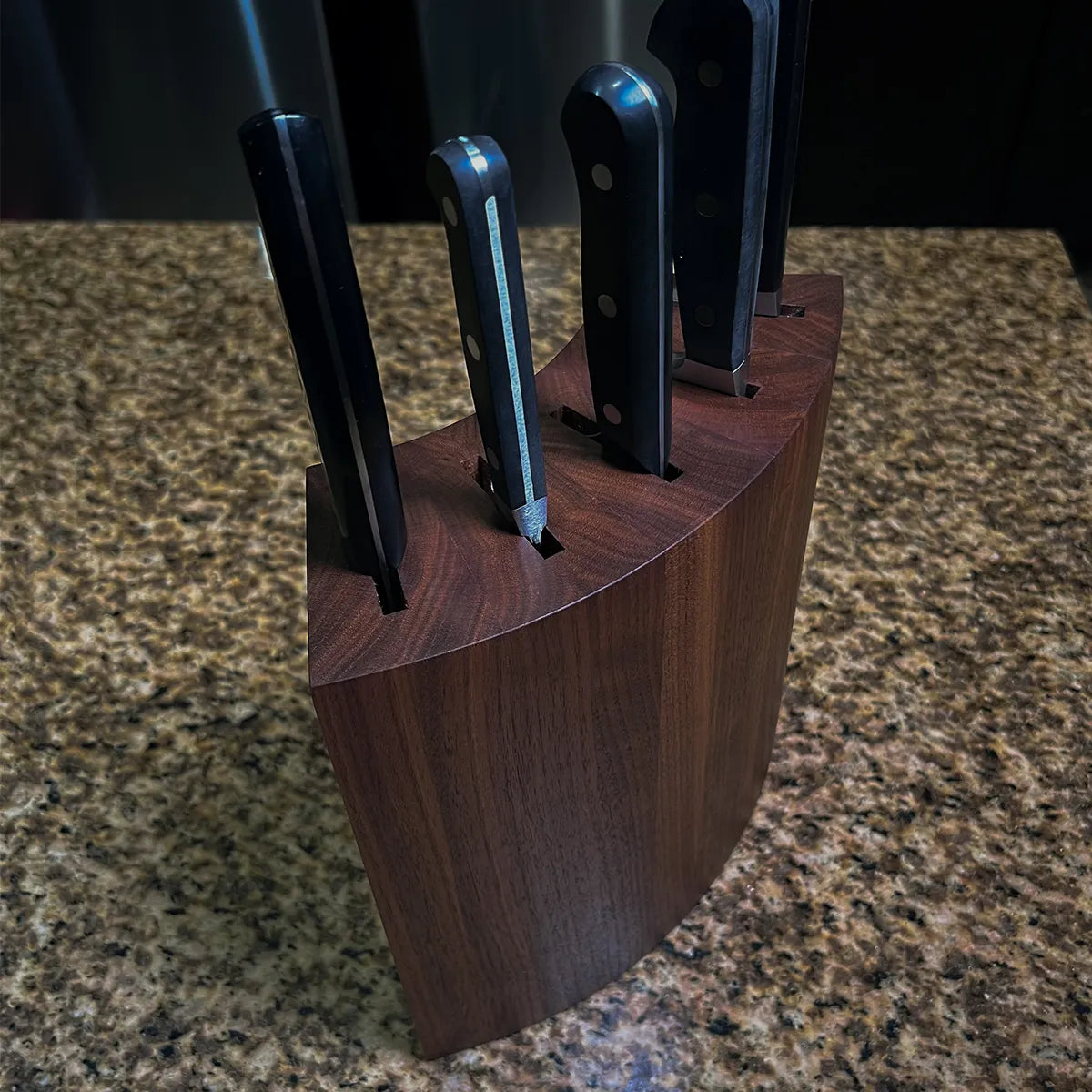 Mid-century modern walnut knife block with curved sculptural form, handcrafted from solid American black walnut.