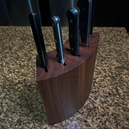 Mid-century modern walnut knife block with curved sculptural form, handcrafted from solid American black walnut.