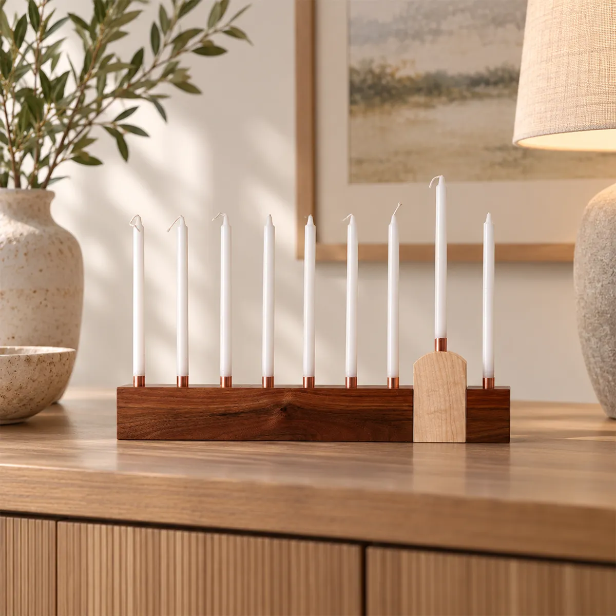 The shamash is supposed to stand apart. We designed the entire menorah around that idea.