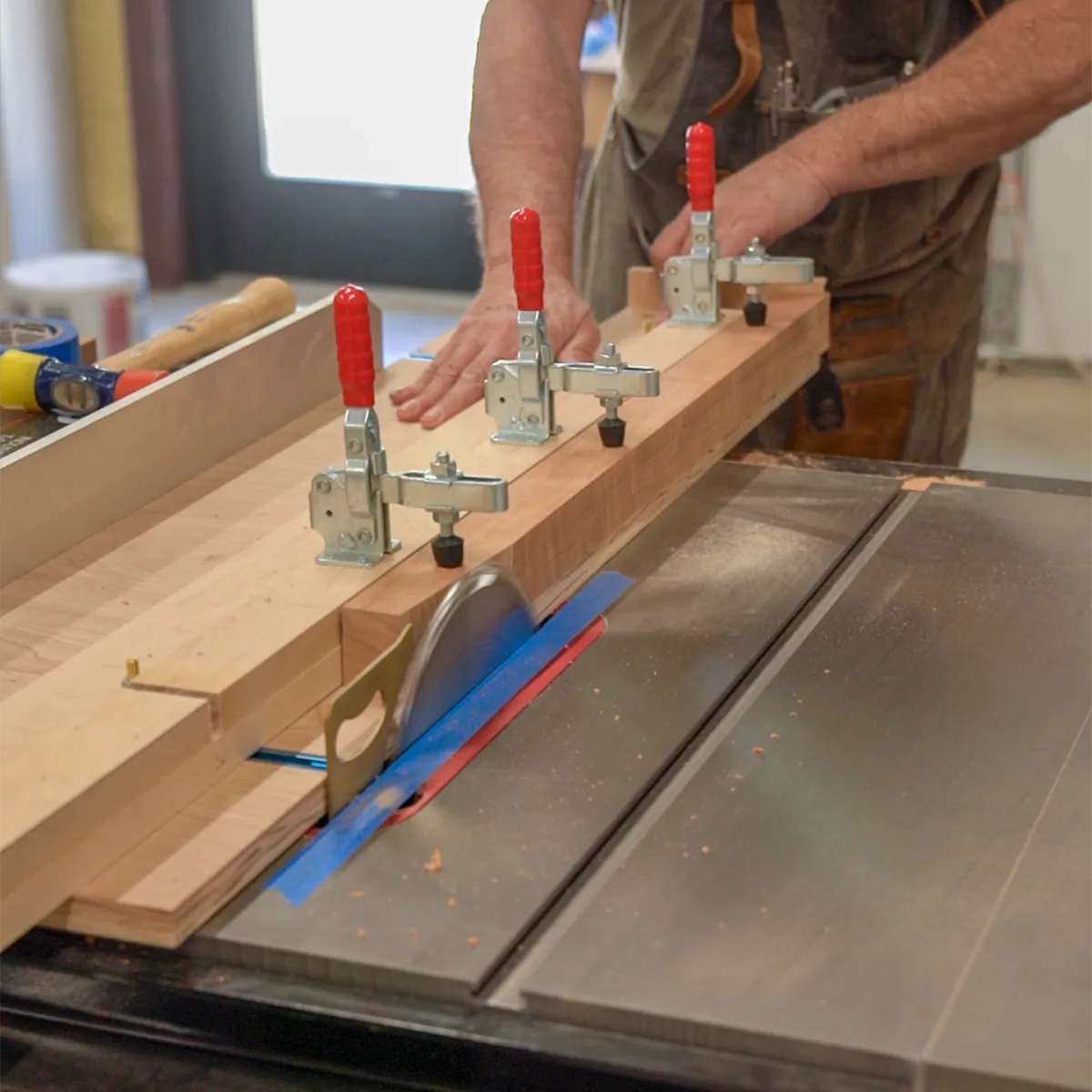 Richard cutting tapered cherry legs for She’s a Lady record player stand, showing handcrafted mid-century modern furniture making process