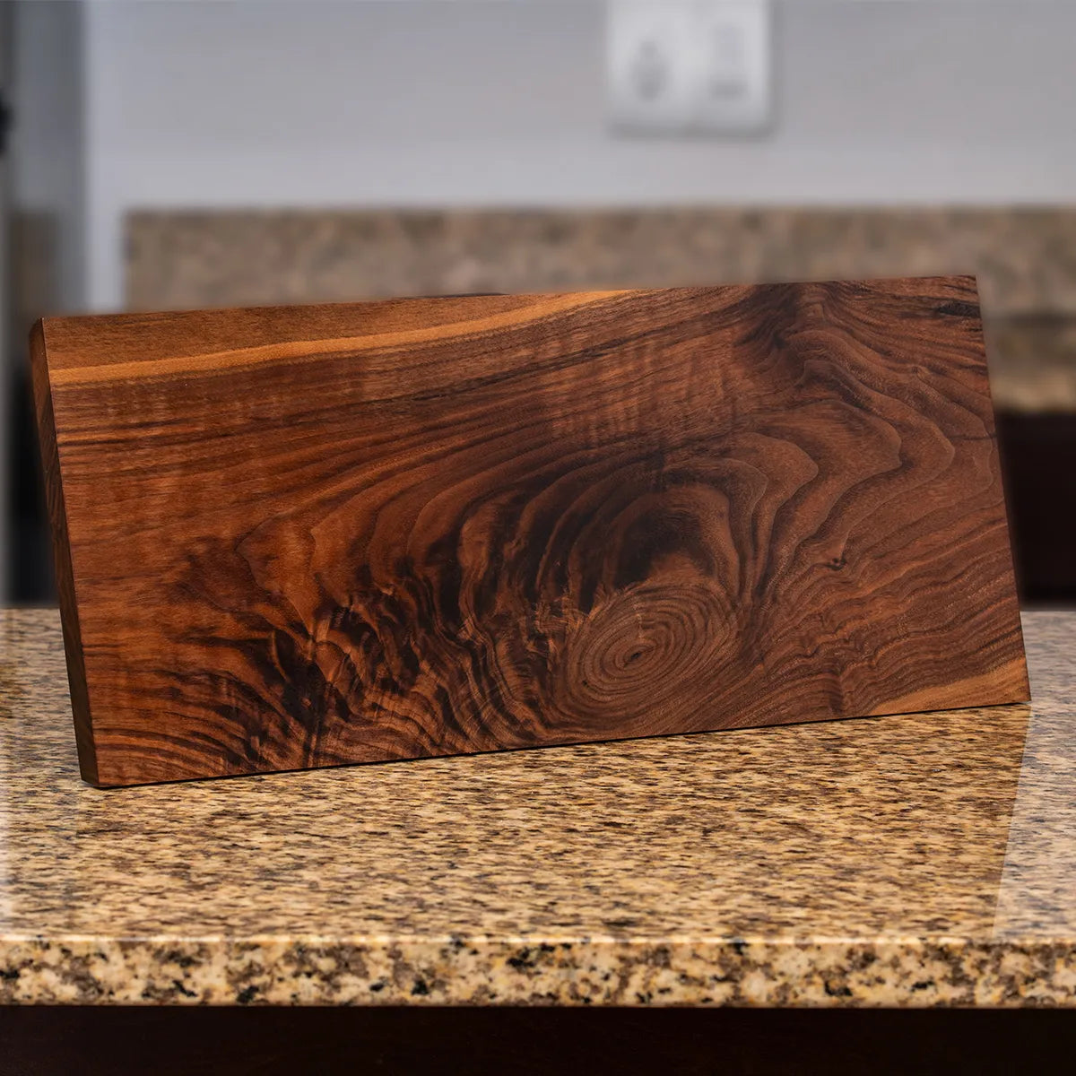 Angled view highlighting chatoyance and depth in figured walnut grain on the Child of Nature knife block