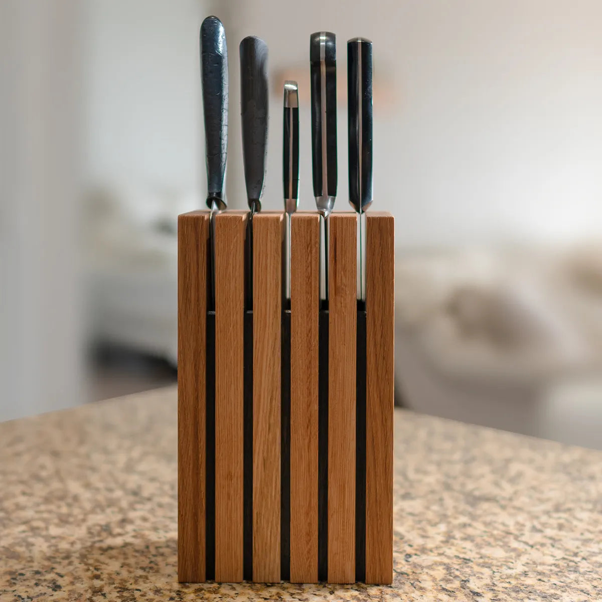 Front view of The Chain knife block in white oak showing overall size and vertical slot design