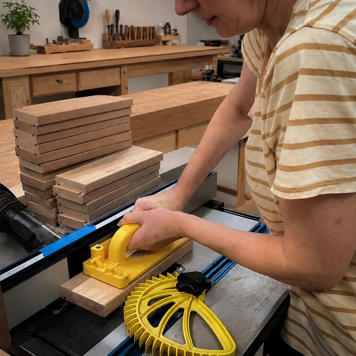 Asha milling divider grooves into white oak blanks for The Chain knife block