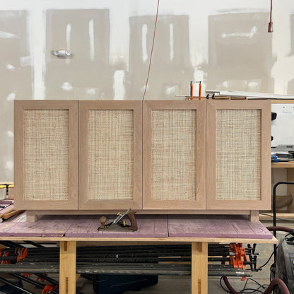 white oak media console with soft close rattan doors